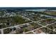 Aerial view of a single-Gathering home in a residential neighborhood with water access at 10401 Sunday Dr, Port Charlotte, FL 33981