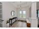 Bright and airy entryway with a console table and bench at 10401 Sunday Dr, Port Charlotte, FL 33981