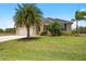 Beautiful single-story home, welcoming front yard with lush landscaping at 15889 Viscount Cir, Port Charlotte, FL 33981
