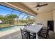 Screened pool area with patio furniture and dining table at 15889 Viscount Cir, Port Charlotte, FL 33981