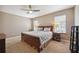 Spacious bedroom with king-size bed, ceiling fan, and ample natural light at 15889 Viscount Cir, Port Charlotte, FL 33981