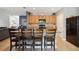Kitchen island with seating, stainless steel appliances, and light wood cabinets at 15889 Viscount Cir, Port Charlotte, FL 33981
