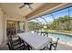 Spacious screened pool area with dining table and view of pool at 15889 Viscount Cir, Port Charlotte, FL 33981