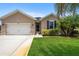 Charming single story home with a two-car garage and manicured lawn at 15889 Viscount Cir, Port Charlotte, FL 33981