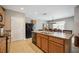 Spacious kitchen with an island, stainless steel appliances, and light wood cabinets at 15889 Viscount Cir, Port Charlotte, FL 33981