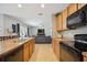 Open concept kitchen with a view of the living room and stainless steel appliances at 15889 Viscount Cir, Port Charlotte, FL 33981