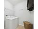 Laundry room with washer, dryer, and shelving at 15889 Viscount Cir, Port Charlotte, FL 33981