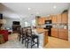 Eat-in kitchen with island seating, stainless steel appliances, and light wood cabinets at 15889 Viscount Cir, Port Charlotte, FL 33981