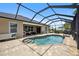 Relaxing pool and patio area; screened enclosure provides shade and privacy at 15889 Viscount Cir, Port Charlotte, FL 33981
