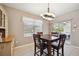Casual dining area with window seat, chandelier, and view of backyard at 15889 Viscount Cir, Port Charlotte, FL 33981