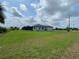 Single-story home with large backyard, screened lanai, and pool at 14364 Appleton Blvd, Port Charlotte, FL 33981