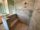 Walk-in shower with built-in seat and pebble floor at 14364 Appleton Blvd, Port Charlotte, FL 33981