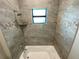 Shower with tile surround and pebble accents at 14364 Appleton Blvd, Port Charlotte, FL 33981