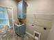 Laundry room with built-in cabinets and sink at 14364 Appleton Blvd, Port Charlotte, FL 33981