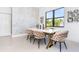 Modern dining room with white table and six cushioned chairs at 11042 Carnegie Ave, Englewood, FL 34224