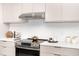 Modern kitchen with stainless steel appliances and white backsplash at 11042 Carnegie Ave, Englewood, FL 34224