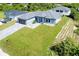 New construction home with grey roof and a nicely landscaped yard at 11042 Carnegie Ave, Englewood, FL 34224