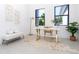 Home office features a stylish desk, comfortable seating, and large windows at 11042 Carnegie Ave, Englewood, FL 34224