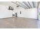 Large garage with epoxy flooring, overhead storage, and laundry hookups at 11042 Carnegie Ave, Englewood, FL 34224