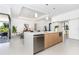 Open concept kitchen with island and stainless steel appliances at 11042 Carnegie Ave, Englewood, FL 34224