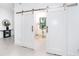 Bright home office with barn doors, a workspace and natural light at 11042 Carnegie Ave, Englewood, FL 34224