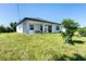 Single story home with covered patio and grassy backyard at 11042 Carnegie Ave, Englewood, FL 34224