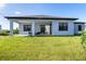 Single story home with covered patio and grassy backyard at 11042 Carnegie Ave, Englewood, FL 34224