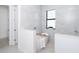 Modern bathroom with a freestanding tub, shower, and marble tile at 11042 Carnegie Ave, Englewood, FL 34224