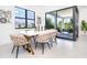 Modern dining area with white table and access to patio at 11042 Carnegie Ave, Englewood, FL 34224
