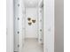 Bright hallway with three closed doors and decorative wall planters at 11042 Carnegie Ave, Englewood, FL 34224