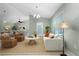 Living room features a neutral color palette, and comfortable seating near the dining area at 13020 Ridgely Cir, Port Charlotte, FL 33981