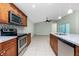 Modern kitchen with stainless steel appliances and granite countertops at 13020 Ridgely Cir, Port Charlotte, FL 33981