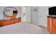 Bedroom with queen bed, wood dresser, and mirror at 245 Spaniards Rd, Placida, FL 33946