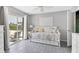 Guest bedroom with daybed, water view, and access to the patio at 245 Spaniards Rd, Placida, FL 33946