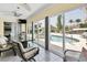 Bright sunroom with pool views and comfortable seating at 245 Spaniards Rd, Placida, FL 33946