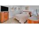 Bedroom with queen bed and wood dresser at 245 Spaniards Rd, Placida, FL 33946