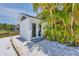 White storage shed with double doors, nestled amongst palm trees at 245 Spaniards Rd, Placida, FL 33946