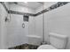 Updated bathroom with a walk-in shower, tile flooring, and a modern toilet at 245 Spaniards Rd, Placida, FL 33946