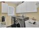 Bright laundry room, featuring washer, dryer, and ample cabinetry at 245 Spaniards Rd, Placida, FL 33946