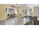 Bright and airy entryway with tile flooring, storage, and a view into the kitchen at 245 Spaniards Rd, Placida, FL 33946