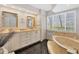 Bathroom with double vanities, a large soaking tub, and tile flooring at 245 Spaniards Rd, Placida, FL 33946