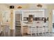 Kitchen with white cabinets, granite counters, stainless steel appliances, and breakfast bar at 245 Spaniards Rd, Placida, FL 33946