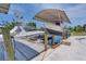 Covered boat lift with two boats, spacious dock, and waterfront access at 245 Spaniards Rd, Placida, FL 33946