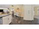 White kitchen cabinets, granite countertops, and an island with seating at 245 Spaniards Rd, Placida, FL 33946