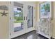 Bright entryway with double doors, tiled floor, and charming coastal decor at 245 Spaniards Rd, Placida, FL 33946