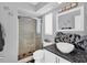 Bathroom with walk-in shower, modern sink, and granite countertop at 245 Spaniards Rd, Placida, FL 33946