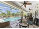 Poolside patio with wicker furniture and table at 123 Antis Dr, Rotonda West, FL 33947