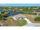 Aerial view of waterfront property with canal access and lush landscaping at 14091 Peekskill Ave, Port Charlotte, FL 33981