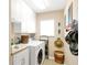 Convenient laundry room with washer, dryer, and ample storage at 14091 Peekskill Ave, Port Charlotte, FL 33981