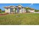 Well-maintained home showcasing a lush lawn, attractive landscaping, and a paved driveway at 14091 Peekskill Ave, Port Charlotte, FL 33981